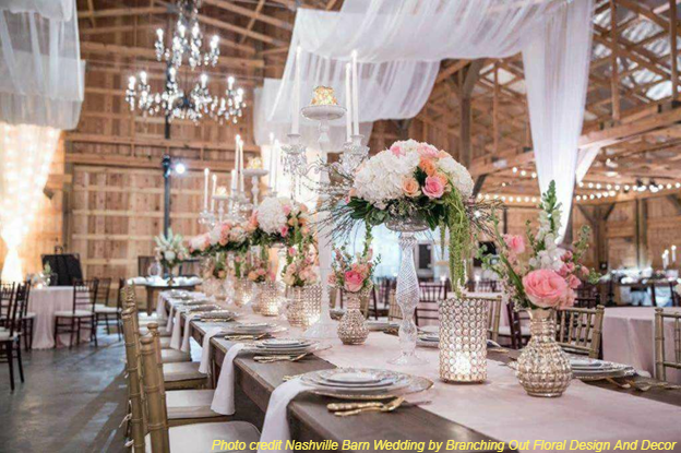 Barn venue with elegant floral centerpieces.